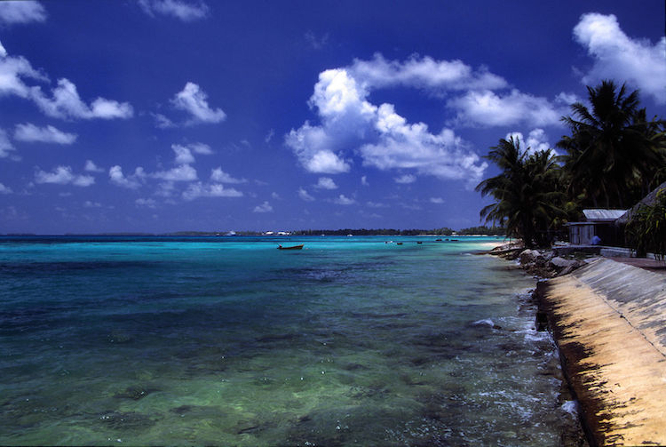 Photo: A beach at Funafuti atoll, Tuvalu, on a sunny day. Credit: Wikimedia Commons.