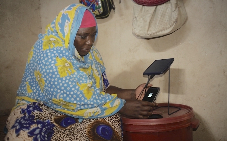 2019] Photo: Mariam Kassim Salum charging her phone on a solar equipment at Kizimkazi village in Zanzibar, Tanzania. Courtesy: Barefoot College