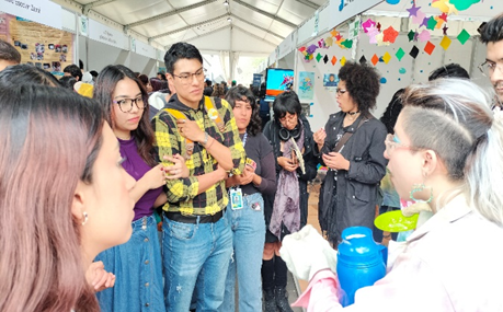 Photo: The Science and Humanities Festival：Attendees listening to an organizer of an exhibition booth. Author: Guillermo Alaya.