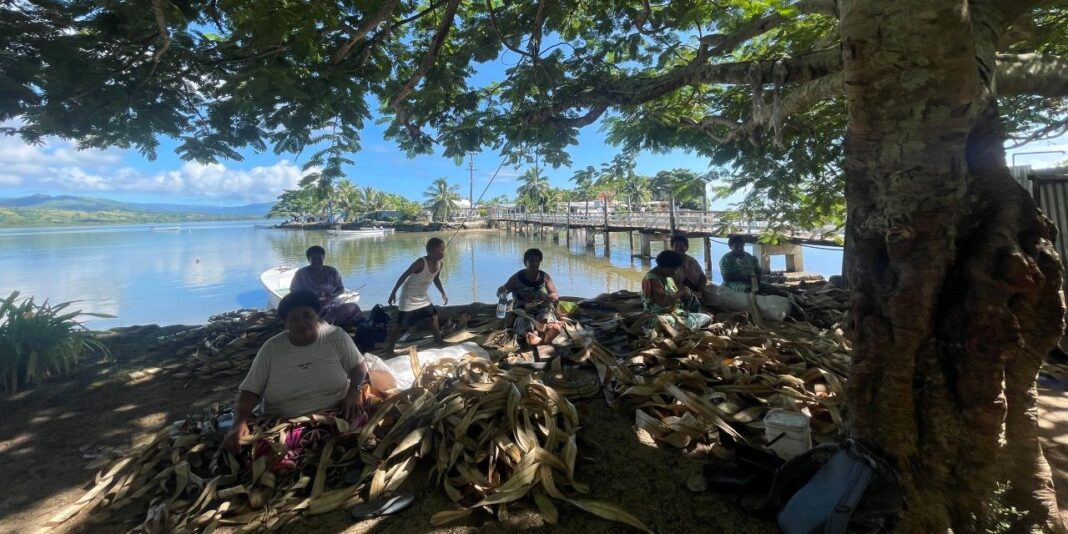 Image: Women on Qoma doing the solesolevaki by the sea / Claudia Fry