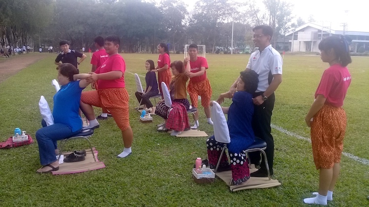 Photo: Dr Poonchai Chitanuntavitaya, Chief Medical Officer of Social Health Enterprise, supervising his trainees while giving massages to visitors to the school for marginalised children, supported by a foundation set up by Princess Maha Chakri Sirindhorn, to empower the students to break into the medical field through an unconventional career path that is providing a multi-faceted approach to addressing the Sustainable Development Goals (SDGs).