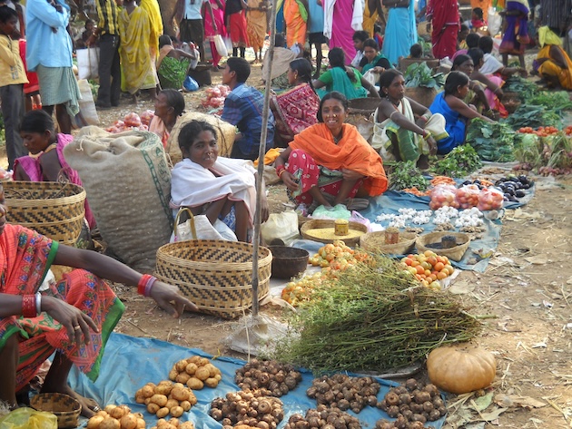 Women from Odisha’s indigenous communities joke and laugh as they sell and barter vegetable, greens, herbs and tubers they grow on the hill slopes of their villages. Credit: Manipadma Jena/IPS