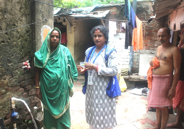 Water partner Aparna Khuntia tests on-premises drinking quality water from a tap for a slum household in Bhubaneswar. Credit: Manipadma Jena/IPS