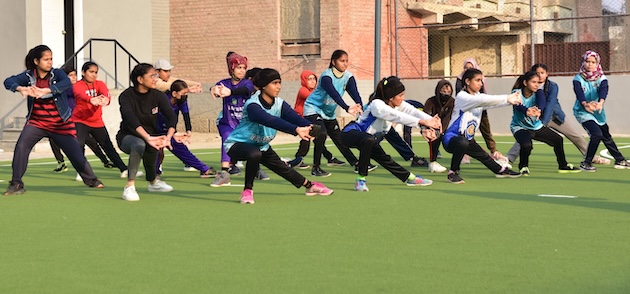 Warm up at the Government Girls Degree College, Jacobabad. Most girls feel awkward and shy when they first wear track pants and T-shirt but do realize they cannot run swiftly in their traditional outfits they are used to wearing. Credit: Erum Baloch/IPS