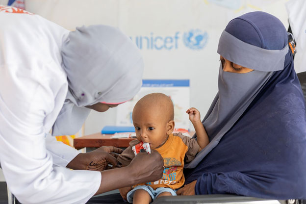A displaced mother from Khartoum brings her child for treatment at the UNICEF-supported Alkarama clinic in Kassala state. Credit: UNICEF/Ahmed Mohamdeen Elfatih