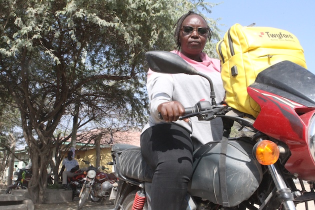 Emily Ndung’e, a motorcycle taxi rider in Garissa Town, northeastern Kenya, says prolonged high temperatures are affecting her income as fewer customers travel during the hottest hours. Credit: Chemtai Kirui/IPS