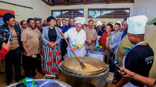 Deputy Minister for Energy, Salome Makamba, cooks during the launch of the project to distribute clean cooking energy in institutions serving more than 100 people, including 52 secondary schools. Credit: Kizito Makoye/IPS