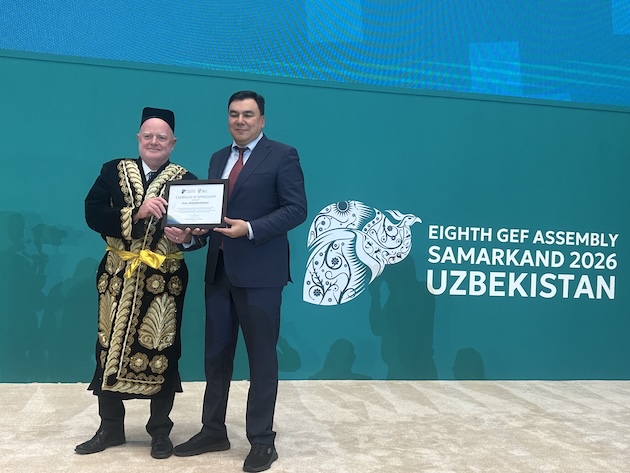 Claude Gascon, interim CEO of the GEF and Aziz Abduhakimov, Minister of Environment of the Republic of Uzbekistan, at the closing ceremony of the Eighth GEF Assembly in Samarkand, Uzbekistan. Gascon was presented with a traditional Uzbek outfit. Credit: Stella Paul/IPS