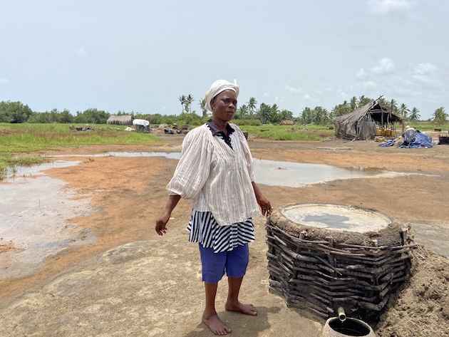 Julienne Dekon collects saline water using the traditional method to make salt in rural Benin. Credit: Neha Banka/IPS